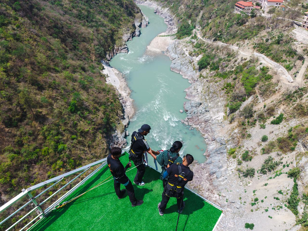 Post-jump celebration with the Devprayag landscape behind